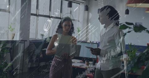 Coworkers Analyzing Digital Data Trends in Modern Workspace