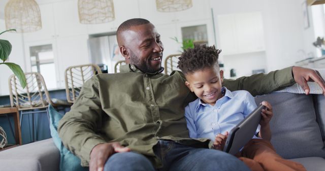 Father and Son Bonding on Couch with Tablet - Download Free Stock Images Pikwizard.com