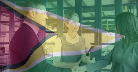Business professionals shaking hands with guyana flag overlay for corporate partnership