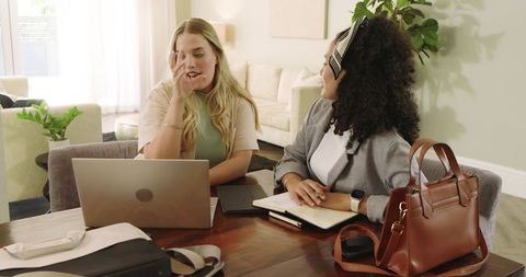 Diverse Female Colleagues Collaborating on Laptop at Home Office