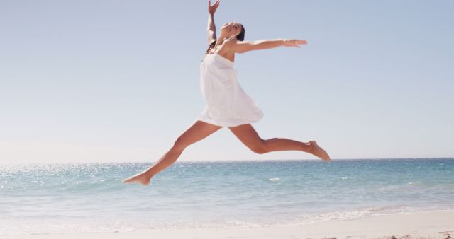 Woman Leaping Joyfully on Beach in Summer Dress - Download Free Stock Images Pikwizard.com