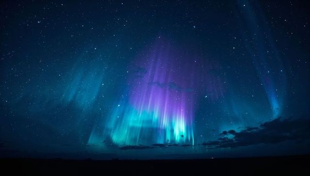 Aurora Borealis Under Starry Night with Ethereal Clouds