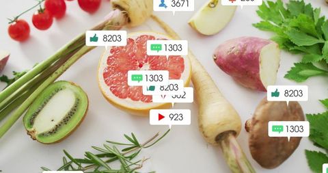 Halved grapefruit flatlay showing kiwi, cherry tomatoes, parsnip, rosemary and social media tags