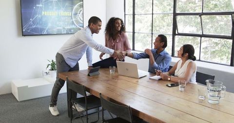 Diverse Team Celebrating Successful Project in Office