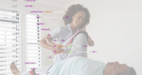 Caregiver assisting senior with resistance band leg exercise on low bed for home rehab mobility