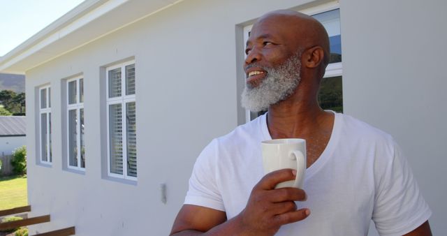 Senior man drinking morning coffee with a smile, enjoying sunrise outdoors - Download Free Stock Images Pikwizard.com