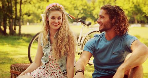 Young Couple Enjoying Sunny Day in Park with Picnic