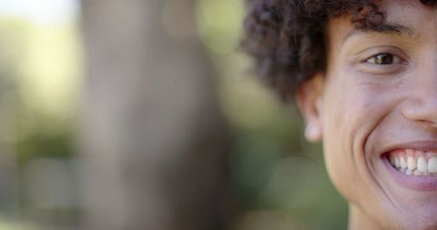 Joyful Young Man Showing Natural Smile Outdoors in Sunny Park