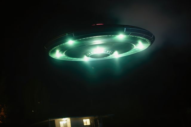Lit ufo hovering above house at night, created using generative ai technology. Unidentified flying object, outer space and aliens concept digitally generated image.