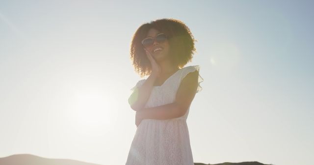 Smiling Woman in White Dress with Curly Hair Enjoying Sunny Outdoors - Download Free Stock Images Pikwizard.com