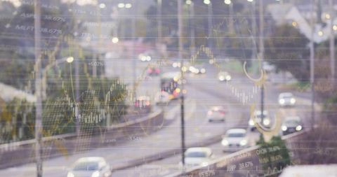Suburban highway traffic at dusk with superimposed financial charts and bokeh