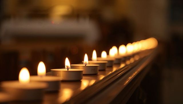 Glowing Tealight Candles Lining Chapel Rail Evoking Warmth and Reverence