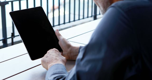 Senior Man Using Digital Tablet Outdoors at Cafe - Download Free Stock Images Pikwizard.com