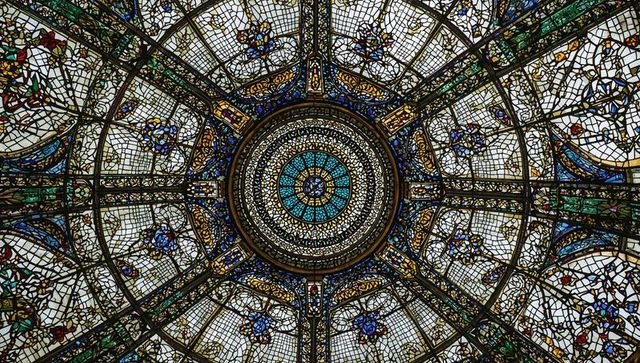 Intricate stained glass dome ceiling with ornate designs
