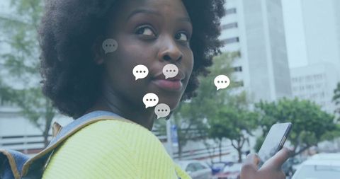 Modern urban woman communicating on smartphone outdoors