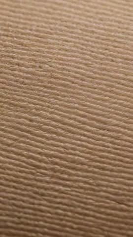 Vertical Macro Video Showing Brown Ridged Paper Texture with Handheld Movement for Inspection
