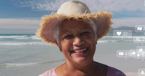 Smiling senior woman enjoying beach with social media interaction icons