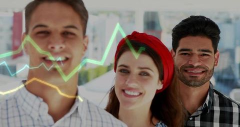Smiling young team standing by office window with colorful line graph overlay and skyline