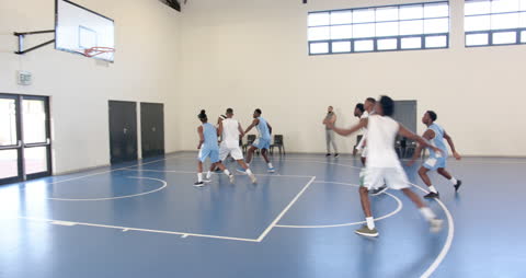 Basketball Team Practicing in Indoor Gym