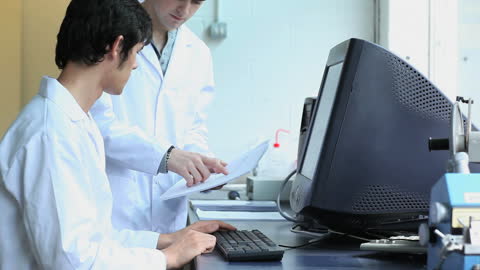 Collaborative Researchers Working in Modern Laboratory With Computers