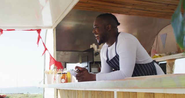 African american man wearing apron ordering food at the food truck. food truck and street food concept