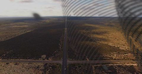 Endless straight desert highway running to horizon with crossroad, sparse vehicles and mesh pattern