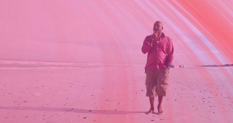 Senior Man in Pink Embracing Tranquil Beach Walk