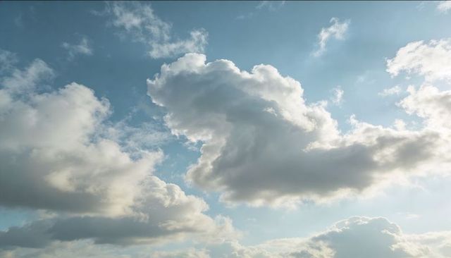 Drifting cumulus cloudscape casting sunlit halos over pale blue sky for calm backgrounds