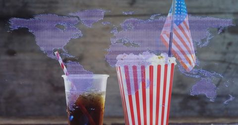 Cinema snacks with world map background conveys global entertainment