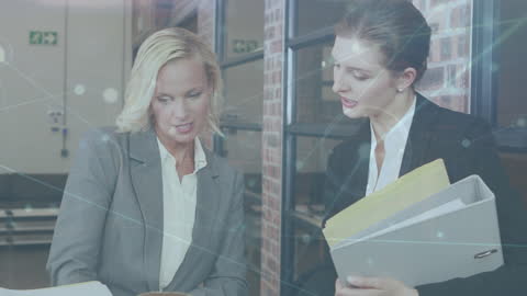 Businesswomen Collaborating with Futuristic Digital Overlay