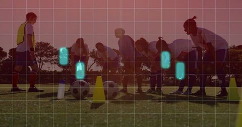 Women Soccer Team Stretching at Sunset on Grass Field with Balls and Cones, Coach Guiding