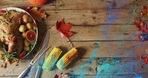 Serving rustic roast chicken with grilled corn and citrus on weathered wood table
