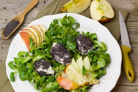 Mâche salad featuring sliced apple and poppy seed-coated goat cheese
