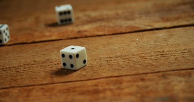 Close-up of Rolling Dice on Wooden Table - Download Free Stock Images Pikwizard.com