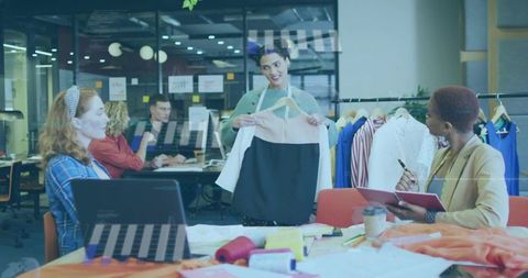 Designer presenting two-tone dress during collaborative fashion workshop and team critique
