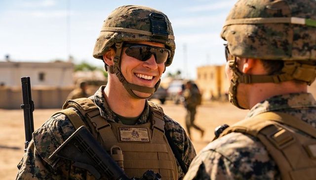 Smiling soldier speaking with comrade at sunlit desert base