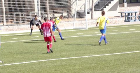 Youth soccer players engaged in intense competition on field