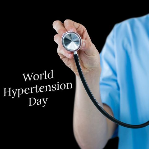 Composite of hand of caucasian doctor with stethoscope and world hypertension day text, copy space. high blood pressure, healthcare, awareness, black background and prevention concept.