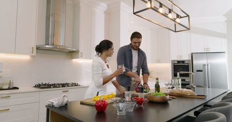 Couple Enjoying Salad Preparation in Modern Kitchen