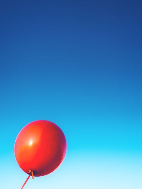 Red Balloon Floating Against Clear Blue Sky - Download Free Stock Photos Pikwizard.com