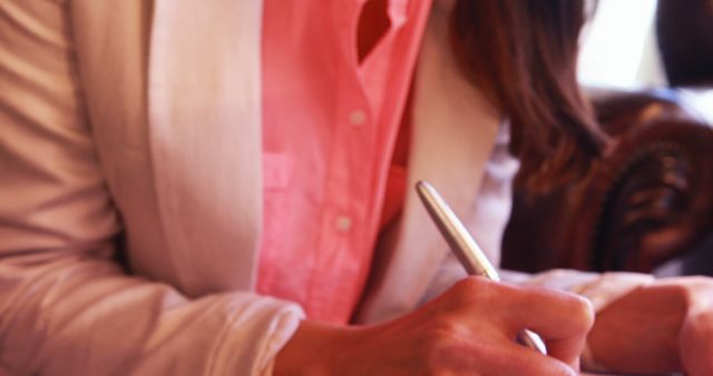 Businesswoman Writing in Notebook During Meeting - Download Free Stock Images Pikwizard.com