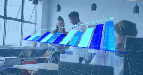 Startup team collaborating over tablet with 3d growth chart overlay in modern office