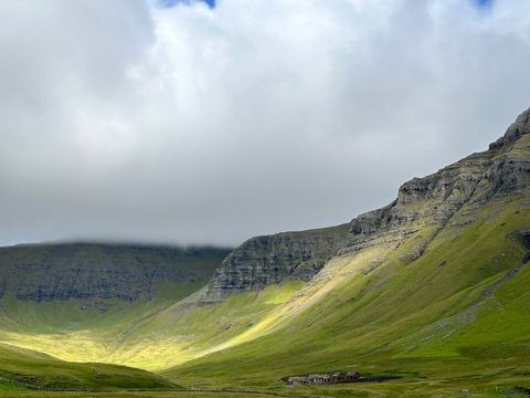 Misty mountain valley road with solitary house