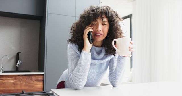 Woman Talking on Phone While Holding Coffee Mug in Kitchen - Download Free Stock Images Pikwizard.com