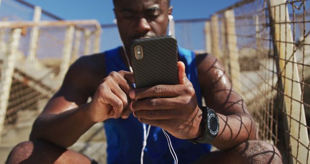 Athletic Man Reflects During Break Using Smartphone at Urban Sport Court - Download Free Stock Images Pikwizard.com