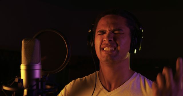 Aspiring Musician Recording with Intensity in Dim Lit Studio - Download Free Stock Images Pikwizard.com