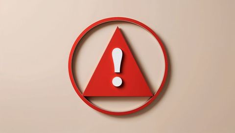 Red alert warning sign with exclamation mark on beige background