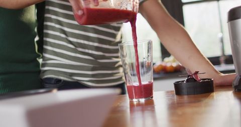 Couples Indoors Making Fruit Smoothie Together at Home