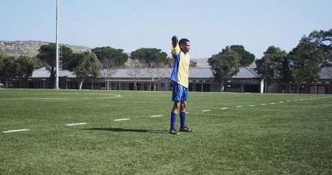 Soccer player stretching on field before match