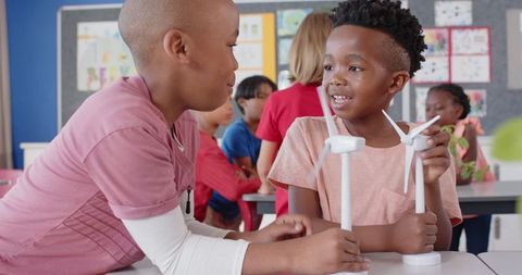 Curious schoolchildren exploring wind energy with models